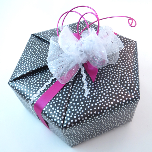 Hexagon wrapped in paper with wire and ribbon decoration